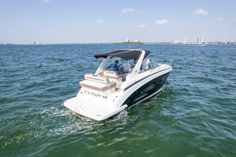 Slide: The Image of 2016 Regal 32 Express boat cruising on open water under clear skies. - 8