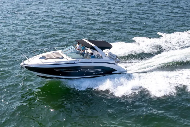 Slide: The Image of 2016 Regal 32 Express boat cruising on open water, creating a dynamic wake. - 9