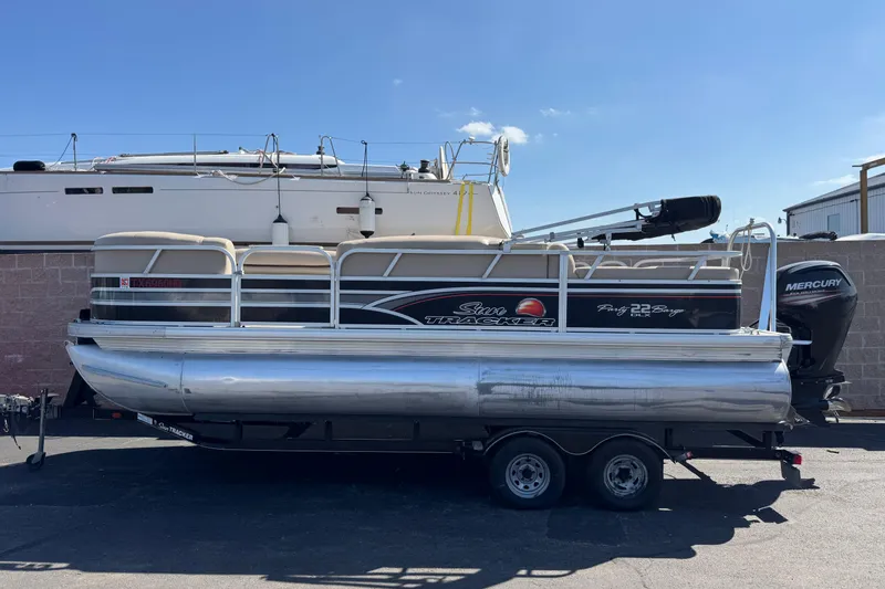 The Image of 2015 Sun Tracker Party Barge 220 DLX pontoon boat with Mercury outboard motor on trailer. - 1