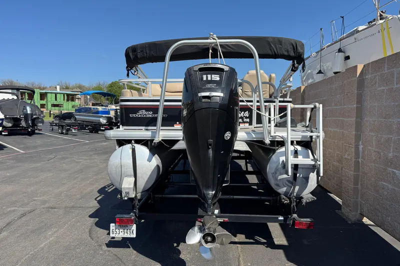 Slide: The Image of 2015 Sun Tracker Party Barge 220 DLX pontoon boat with Mercury 115 engine, parked outdoors. - 4