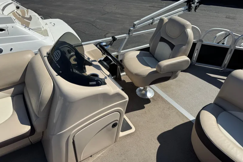 Slide: The Image of 2015 Sun Tracker Party Barge 220 DLX interior with helm and seating area. - 5