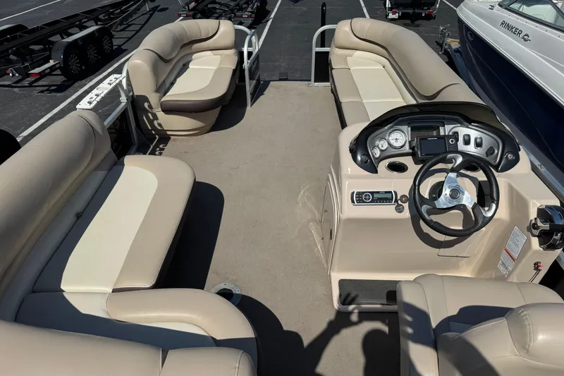 Slide: The Image of 2015 Sun Tracker Party Barge 220 DLX interior with spacious seating and modern helm. - 8