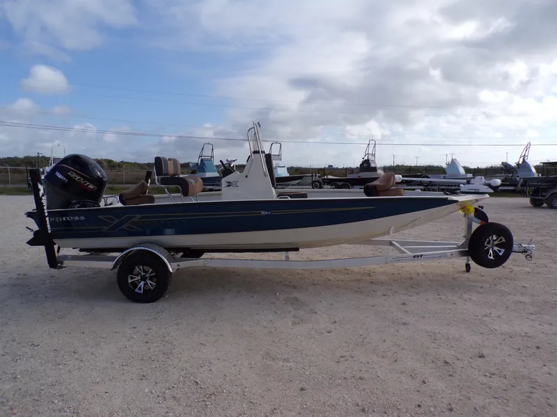 Slide: The Image of 2026 Xpress H20BAY boat on trailer, side view. - 11