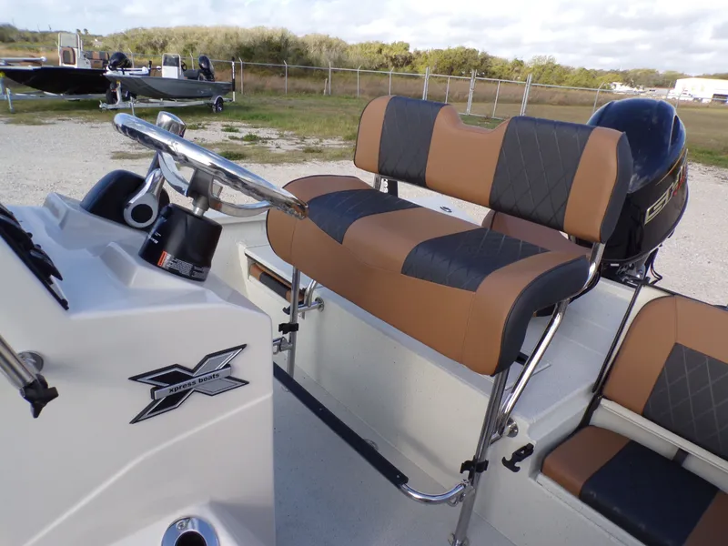 Slide: The Image of 2026 Xpress H20BAY boat with brown and black seating. - 25