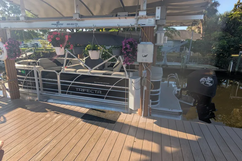 The Image of Pontoon boat Trifecta 20CLE 2.75, 2021 model, docked with floral decorations. - 1