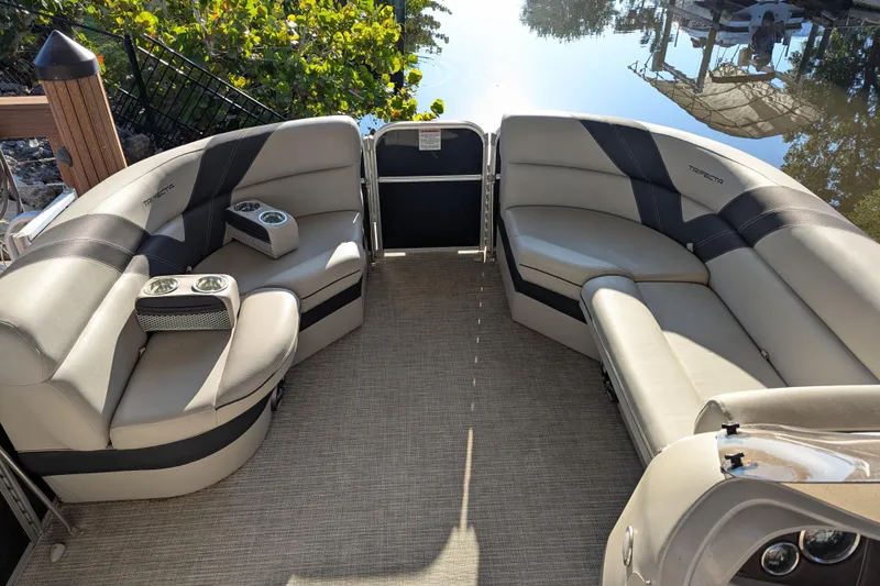 Slide: The Image of Luxurious seating on a 2021 Trifecta 20CLE 2.75 pontoon boat, featuring cup holders and elegant design. - 12