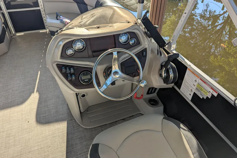 Slide: The Image of Steering console of a 2021 Trifecta 20CLE 2.75 pontoon boat with gauges and controls. - 15