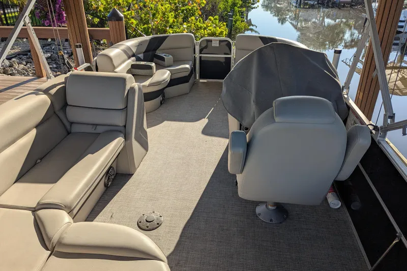 Slide: The Image of Interior of a 2021 Trifecta 20CLE 2.75 pontoon boat with plush seating and helm. - 4