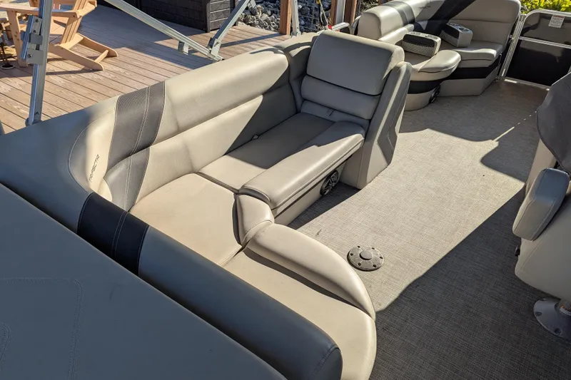 Slide: The Image of 2021 Trifecta 20CLE 2.75 pontoon boat interior with beige seating and carpeted floor. - 6