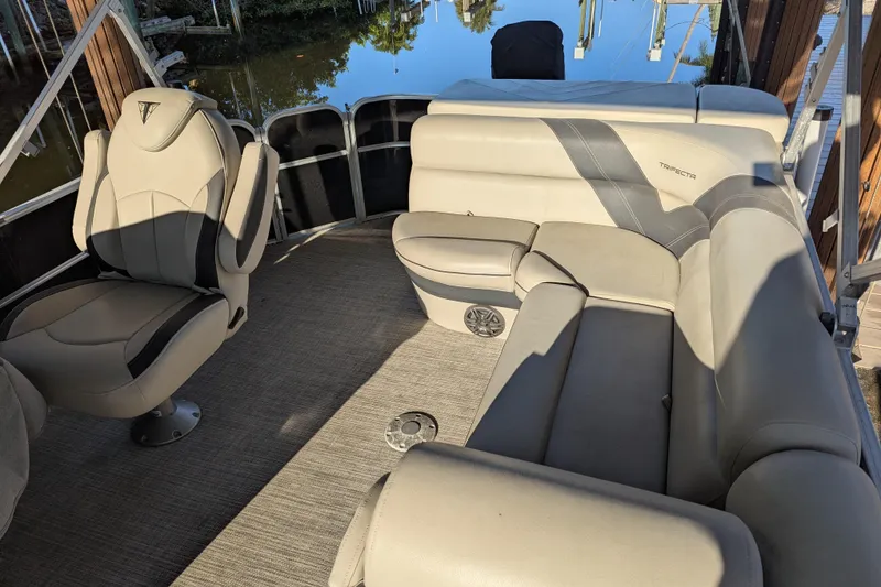 Slide: The Image of 2021 Trifecta 20CLE 2.75 pontoon boat interior with plush seating and modern design. - 7