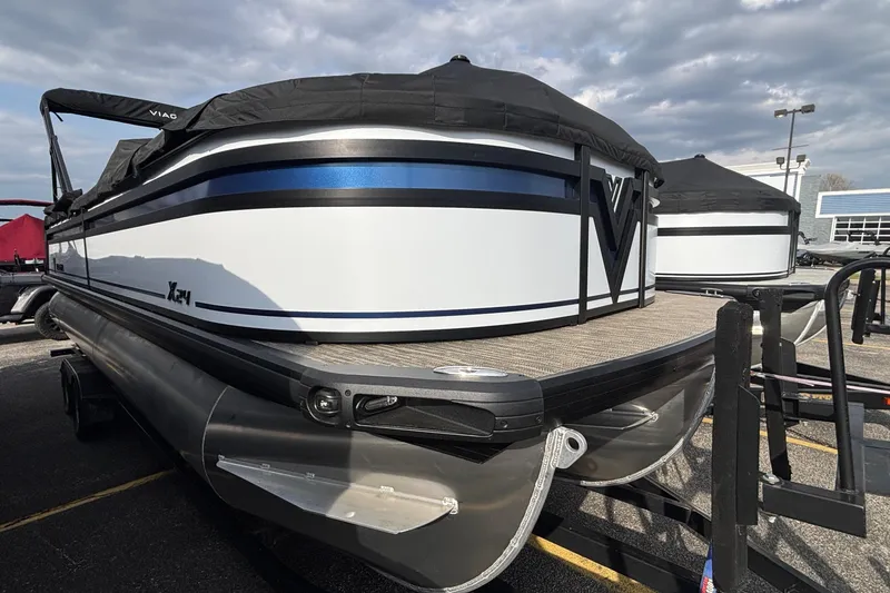 The Image of 2026 Viaggio Lago X24U pontoon boat with sleek design on display in a parking lot. - 1