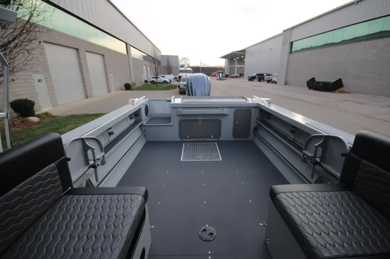 Slide: The Image of 2025 Weldcraft 240 Maverick DV boat interior, spacious seating, industrial setting. - 10