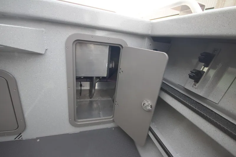 Slide: The Image of 2025 Weldcraft 240 Maverick DV boat storage compartment with open door. - 11