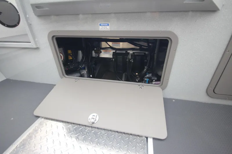 Slide: The Image of Open storage compartment in 2025 Weldcraft 240 Maverick DV boat interior. - 13