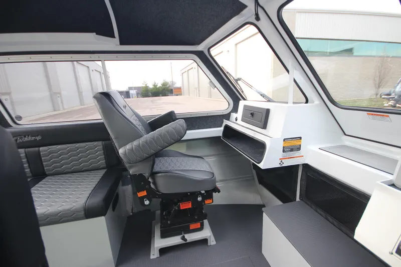 Slide: The Image of Interior of 2025 Weldcraft 240 Maverick DV boat, featuring modern seating and dashboard. - 19