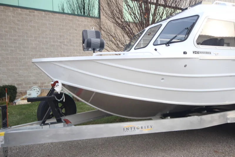 Slide: The Image of 2025 Weldcraft 240 Maverick DV boat on trailer, parked outdoors. - 2