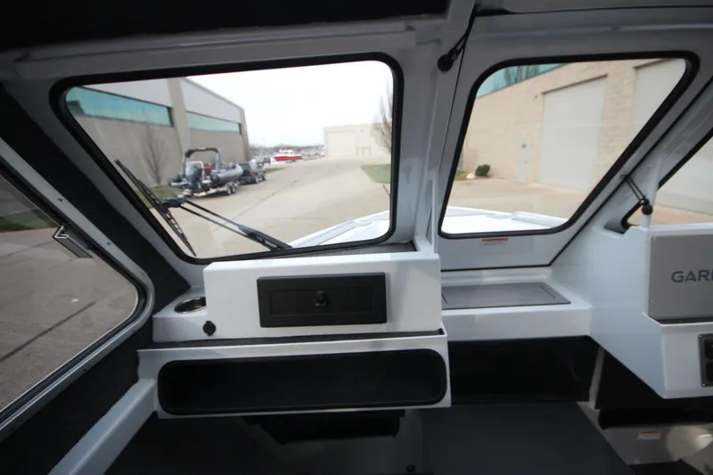 Slide: The Image of Interior view of 2025 Weldcraft 240 Maverick DV boat, showcasing dashboard and windows. - 20