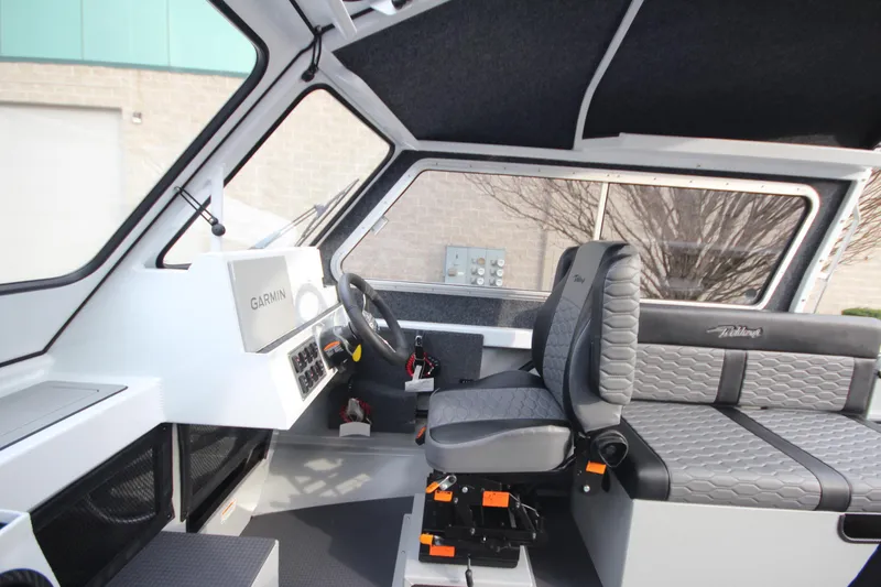 Slide: The Image of Interior of 2025 Weldcraft 240 Maverick DV boat, featuring modern seating and controls. - 21