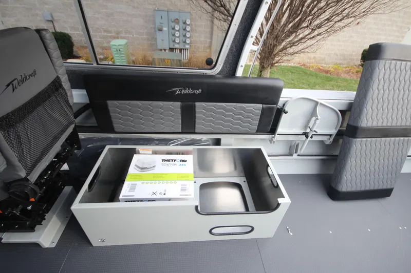 Slide: The Image of 2025 Weldcraft 240 Maverick DV interior with storage compartment and seating. - 27