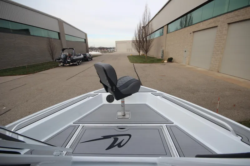 Slide: The Image of 2025 Weldcraft 240 Maverick DV boat with seat, parked outside industrial building. - 37