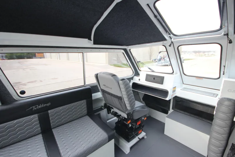 Slide: The Image of Interior of 2025 Weldcraft 240 Maverick DV boat, featuring modern seating and dashboard. - 4