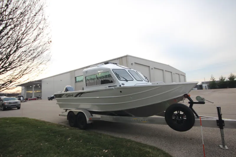 Slide: The Image of 2025 Weldcraft 240 Maverick DV boat on trailer outside warehouse. - 5