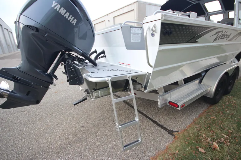 Slide: The Image of 2025 Weldcraft 240 Maverick DV boat with Yamaha motor and ladder, parked on pavement. - 8