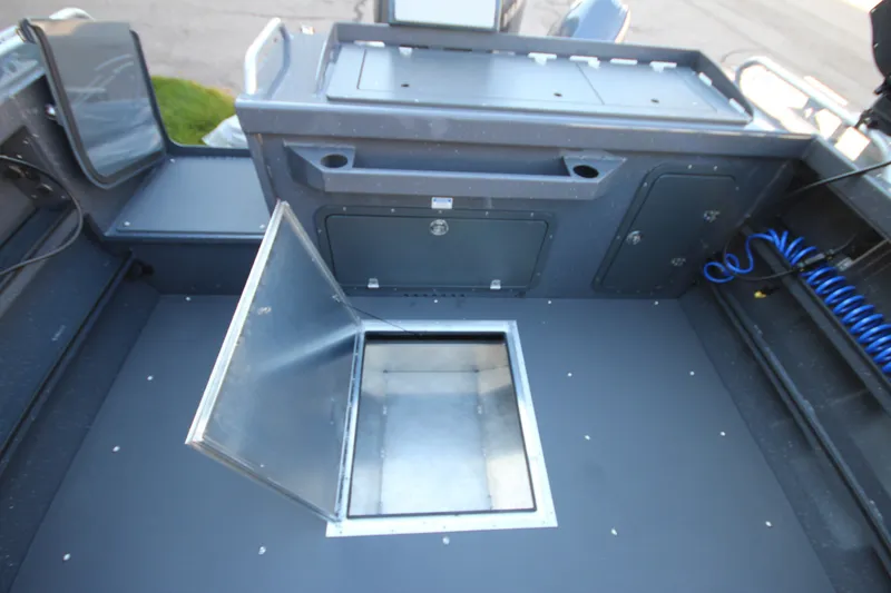 Slide: The Image of 2027 Weldcraft 240 Maverick DV boat interior with open storage compartment. - 18