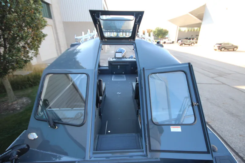 Slide: The Image of 2027 Weldcraft 240 Maverick DV boat with open cabin doors, parked outdoors. - 38