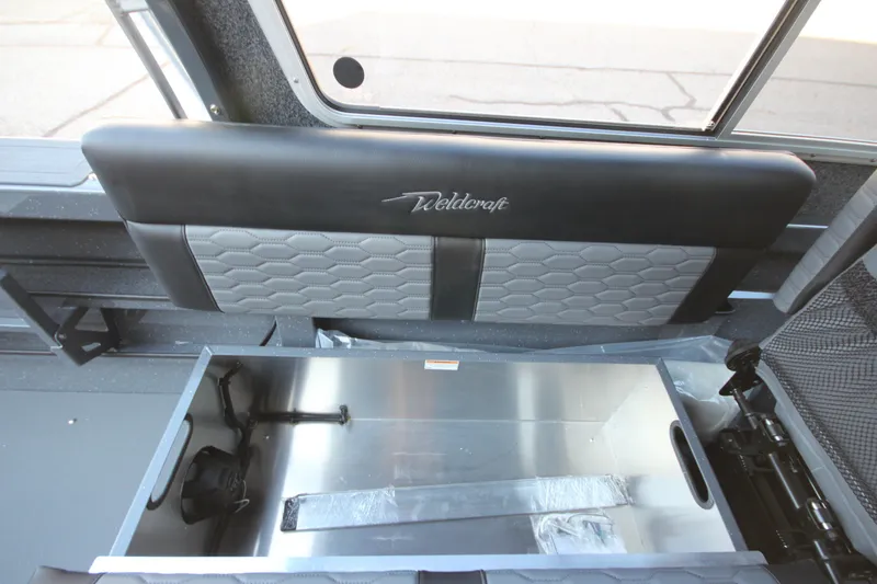 Slide: The Image of Interior view of 2027 Weldcraft 240 Maverick DV boat, featuring storage compartment and seating. - 23