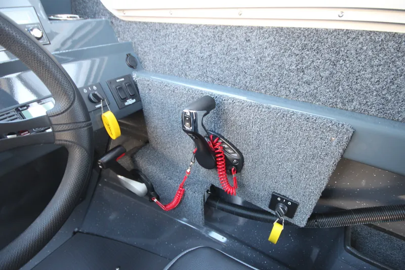 Slide: The Image of Interior controls of 2027 Weldcraft 240 Maverick DV boat, featuring steering wheel and throttle. - 33