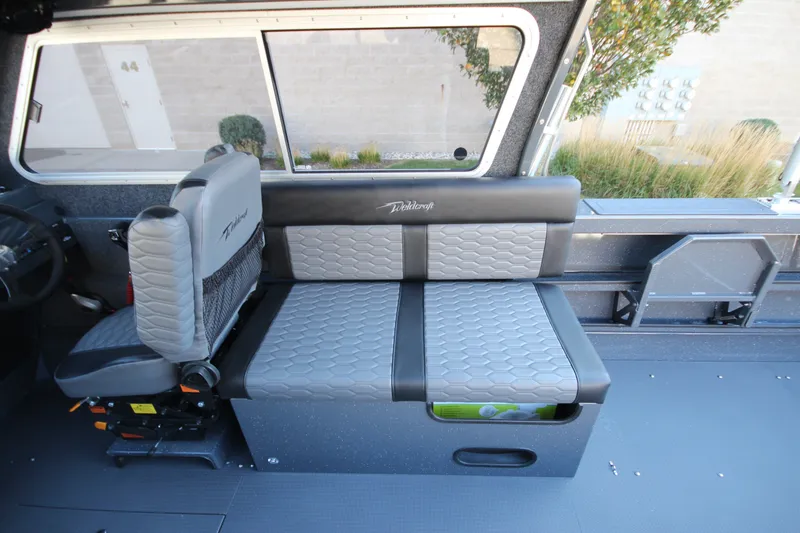 Slide: The Image of Interior of 2027 Weldcraft 240 Maverick DV boat with gray seating and storage. - 24
