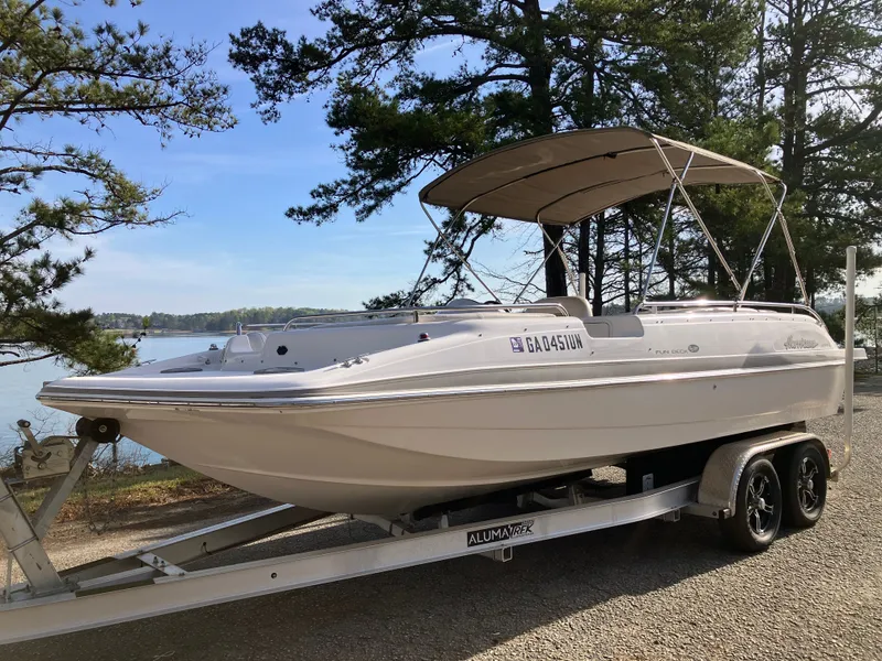 Slide: The Image of 2004 Hurricane 201 GS boat on trailer by the lake. - 1