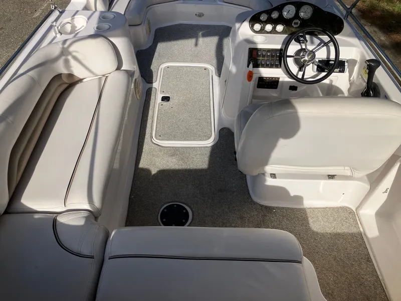 Slide: The Image of Interior of a 2004 Hurricane 201 GS boat with steering wheel and seating. - 11