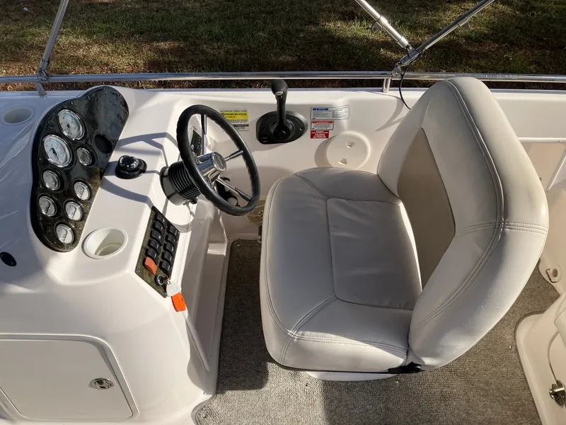 Slide: The Image of Interior of a 2004 Hurricane 201 GS boat with steering console. - 13