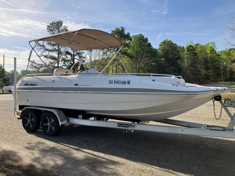 Slide: The Image of 2004 Hurricane 201 GS boat parked on trailer outdoors. - 3