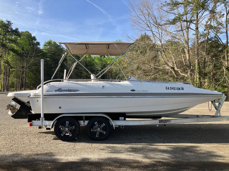 Slide: The Image of 2004 Hurricane 201 GS boat on trailer parked outdoors. - 4