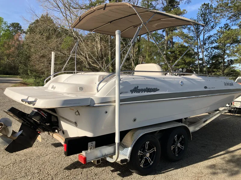 Slide: The Image of 2004 Hurricane 201 GS boat parked on trailer outdoors. - 5