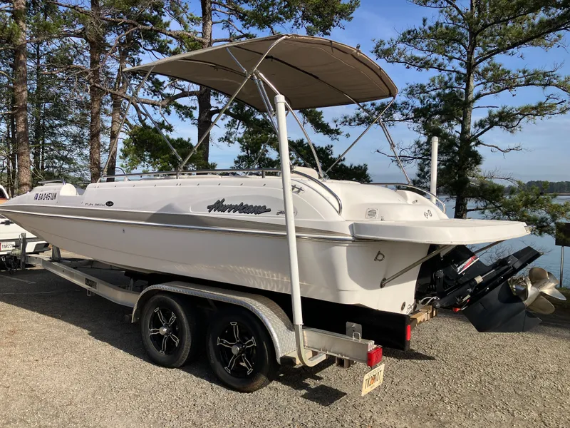 Slide: The Image of 2004 Hurricane 201 GS boat on trailer, parked outdoors. - 7