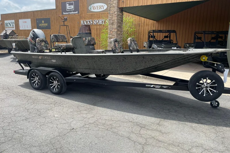 The Image of 2026 War Eagle 961 Blackhawk boat on trailer, parked outside Mack's Sport Shop. - 0