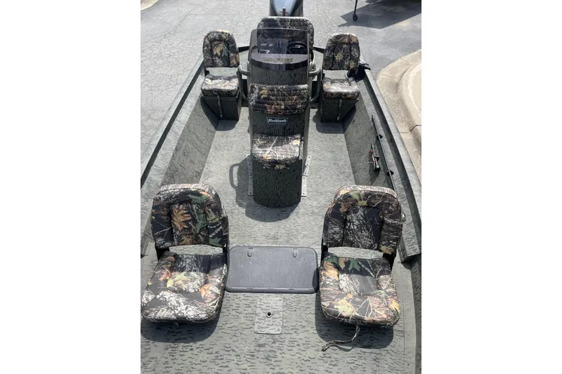 Slide: The Image of 2026 War Eagle 961 Blackhawk boat interior with camouflage seating and console. - 11