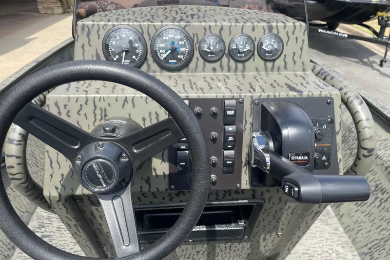 Slide: The Image of 2026 War Eagle 961 Blackhawk boat dashboard with steering wheel and Yamaha controls. - 14