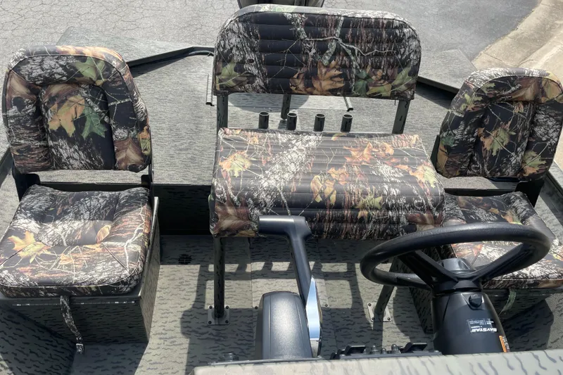 Slide: The Image of 2026 War Eagle 961 Blackhawk boat interior with camouflage seating and steering wheel. - 17