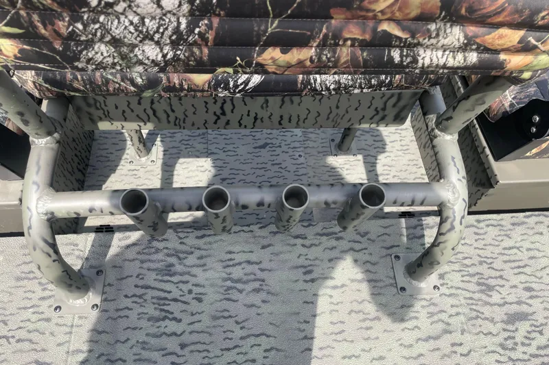 Slide: The Image of 2026 War Eagle 961 Blackhawk boat interior with camo seating and rod holders. - 19