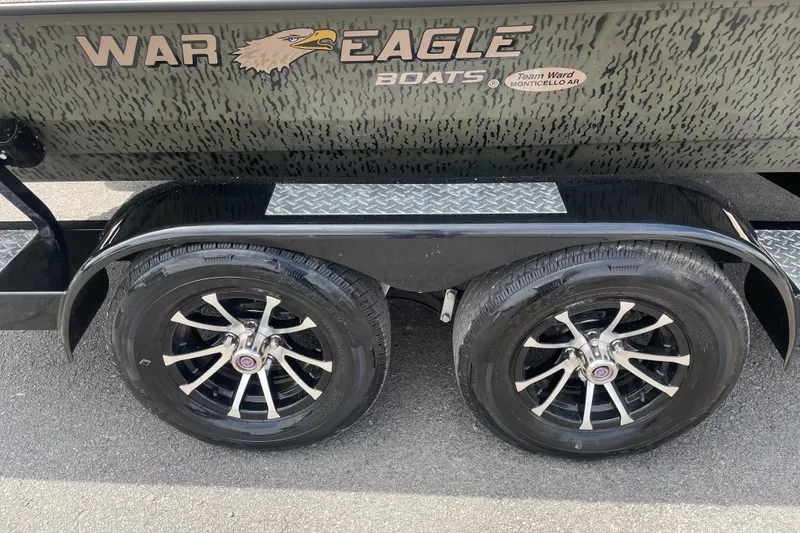 Slide: The Image of 2026 War Eagle 961 Blackhawk boat trailer with dual black alloy wheels. - 2