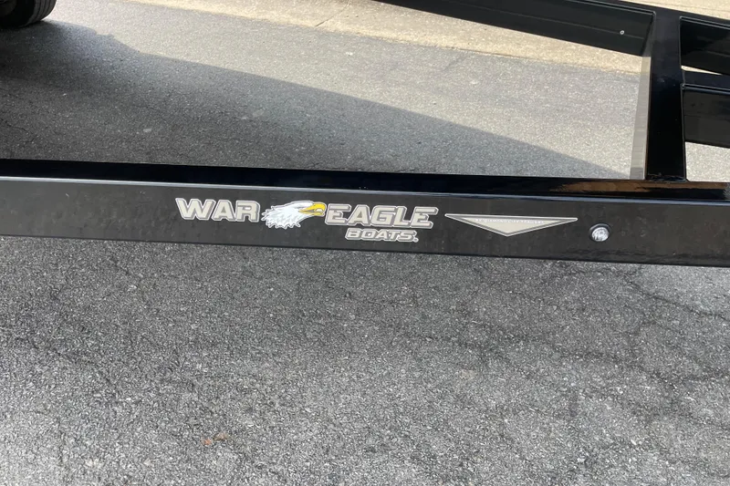 Slide: The Image of 2026 War Eagle 961 Blackhawk boat trailer on asphalt surface. - 4