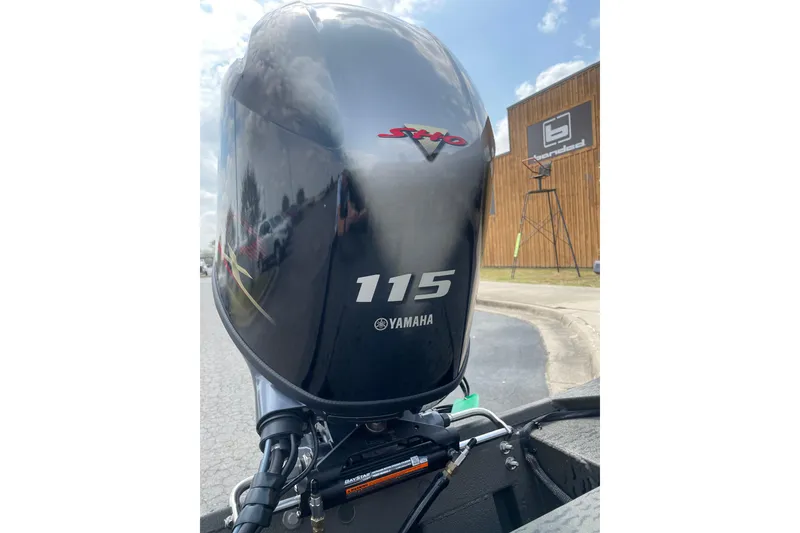 Slide: The Image of 2026 War Eagle 961 Blackhawk with Yamaha 115 engine, outdoor display. - 6