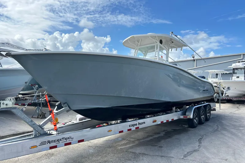 The Image of 2015 Cape Horn 32 XS boat on trailer under blue sky. - 0