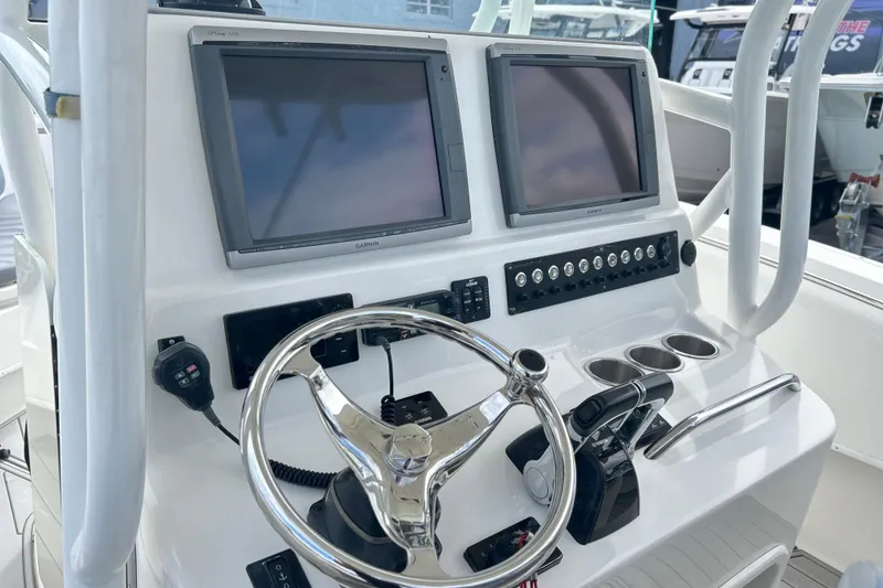 Slide: The Image of 2015 Cape Horn 32 XS boat dashboard with dual Garmin displays and steering wheel. - 10