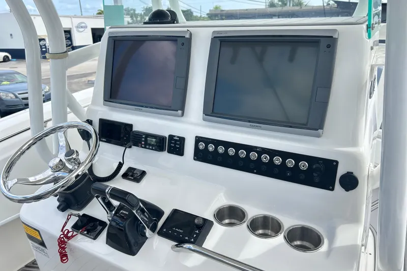 Slide: The Image of 2015 Cape Horn 32 XS boat dashboard with dual Garmin screens and steering wheel. - 11